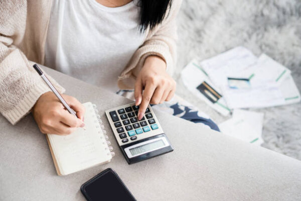 Woman calculating costs and making budget estimates 