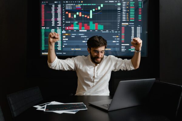 An image illustrating a man doing paper trading with his system.