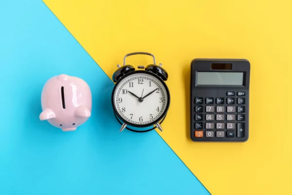 A piggy bank , aan alarm clock and a calculator