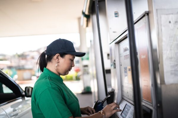 A woman filling her car tank with gas