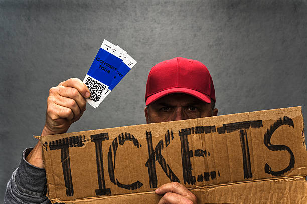 Man Holding up tickets for event from ticket sites