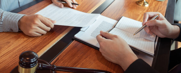 Two people signing a contract