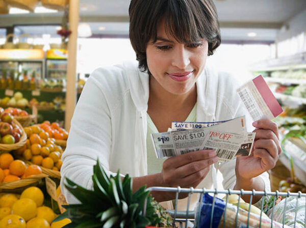 Lady looking at slip.
#Save Money On Groceries.